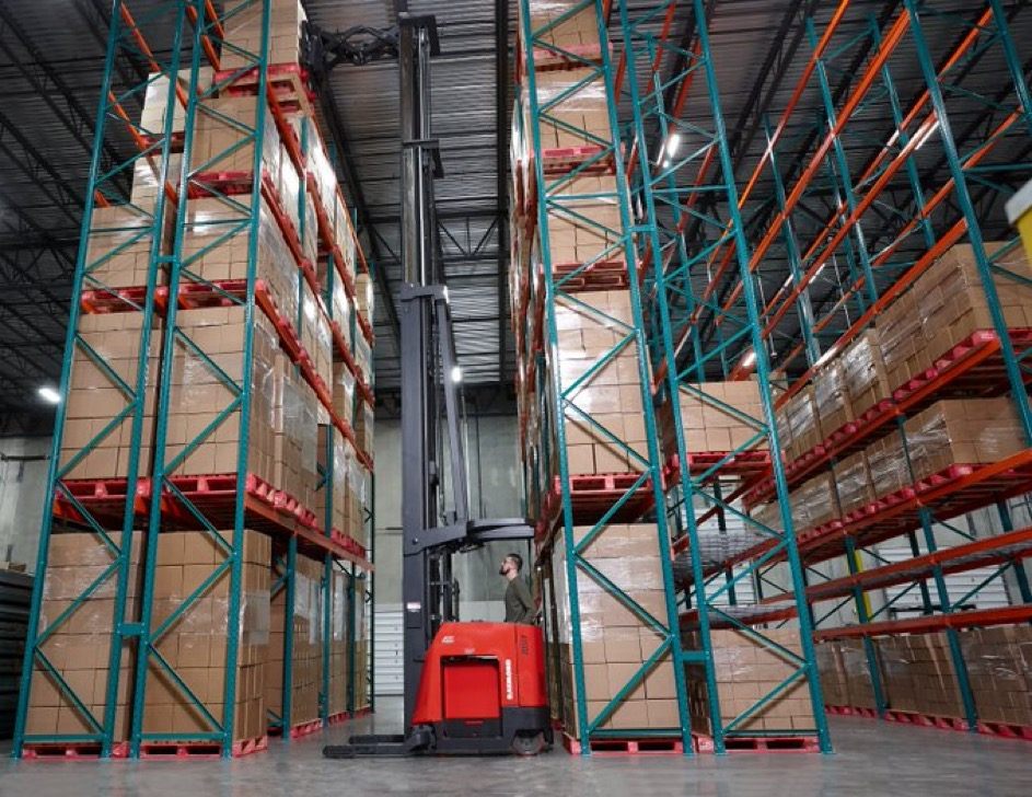 High-reach forklift operating inside a Broadi warehouse